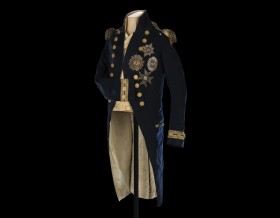 A long dark blue naval coat decorated with gold trim, buttons and medals.