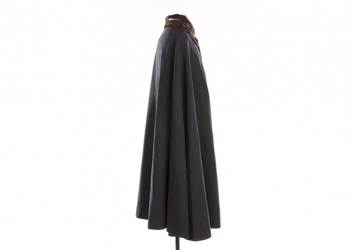 a photo of a long grey cloak with brass button and brown suede collar