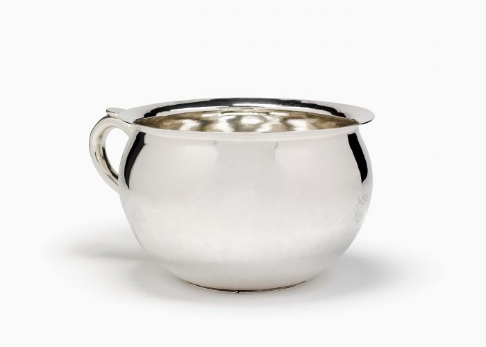 a photo of a gleaming silver chamberpot
