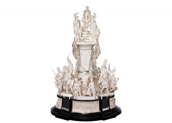 A photo of a silver trophy with a prolific decoration of Napoleonic figures in silver