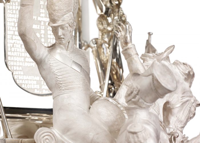 A photo of a large silver trophy with a prolific decoration of Napoleonic soldier figures