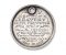 a photo of a silver medal with the inscription: Reward of Bravery to Cpl Brewster from the Officers of the Coldstream Gds for his action of Waterloo June 13, 1815.