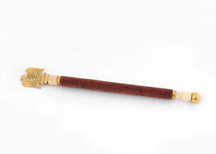 a photo of a baton with a golden eagle on the top