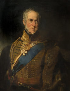 a portrait of a middle aged man in blue sash