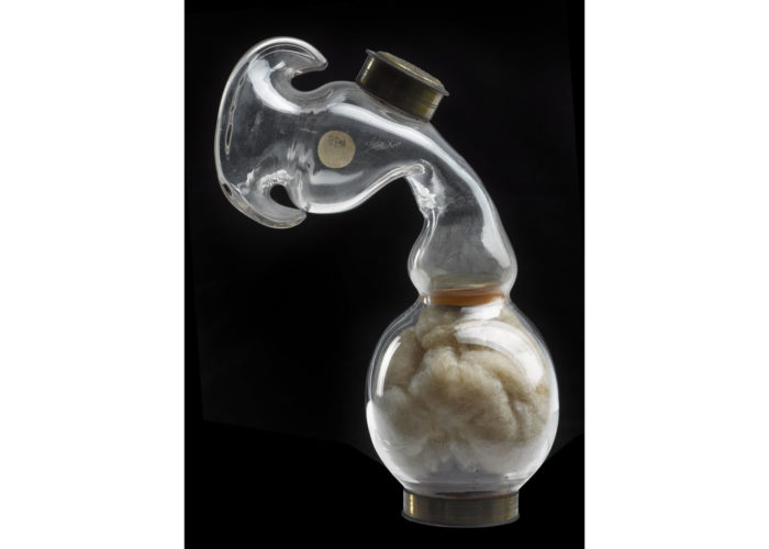 A photograph of a glass inhaler with cotton wool at the bottom.