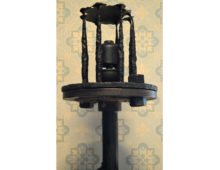 A photograph of a cast iron steam whistle.