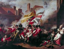 A painting of a battle scene within a town. Soldiers dressed in red military jackets can be seen fighting below two large union jack flags. In the centre of the frame a a man can be seen dying with other soldiers hodling him up. To the right of the frame civilians can be seen fleeing the scene.
