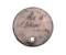 A photograph of a small metal disc against a white background. The disc is engraved with the words ‘This is a token’. At the bottom there is a small hole, such that a chain could be passed through to wear the token as a necklace.