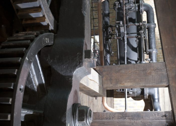 A modern photograph of the inner workings of the Bolton and Watt steam engine inside a museum