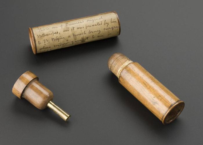 Laennec stethoscope made by Laennec, c.1820. Front 3/4 view of whole object against graduated grey background