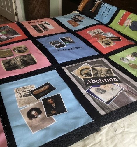 a quilt made from collaged pictures and phrases to do with the abolition of slavery