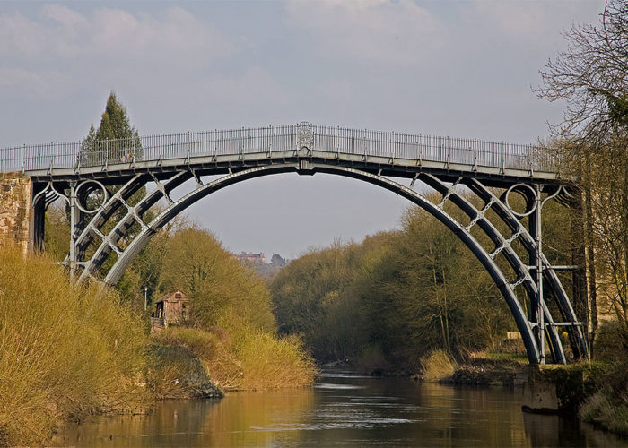 A photo of an iron bridge over a river