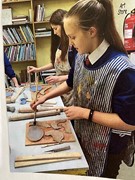 students designing clay artworks